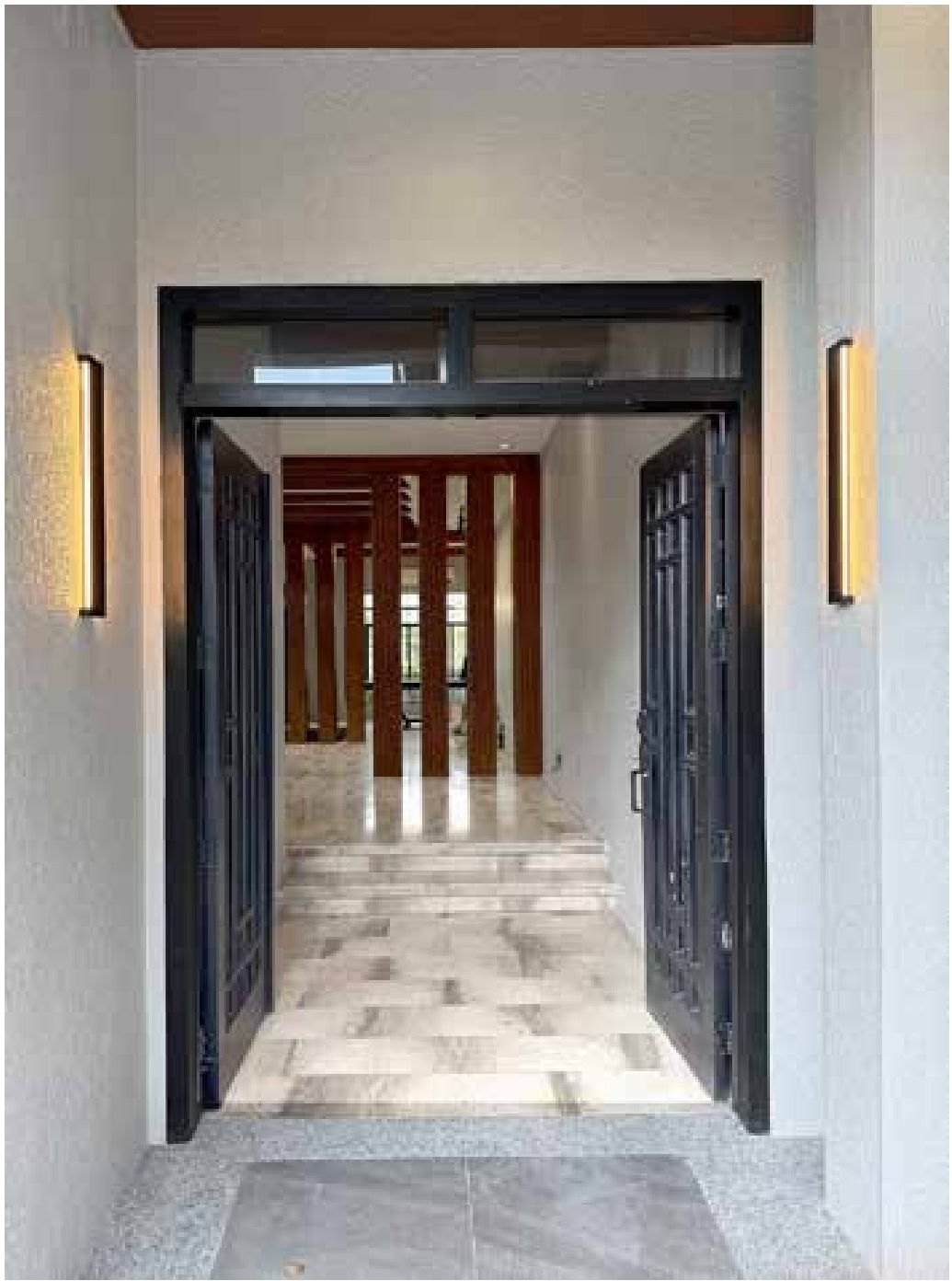 Interior with wooden slat room dividers and marble flooring