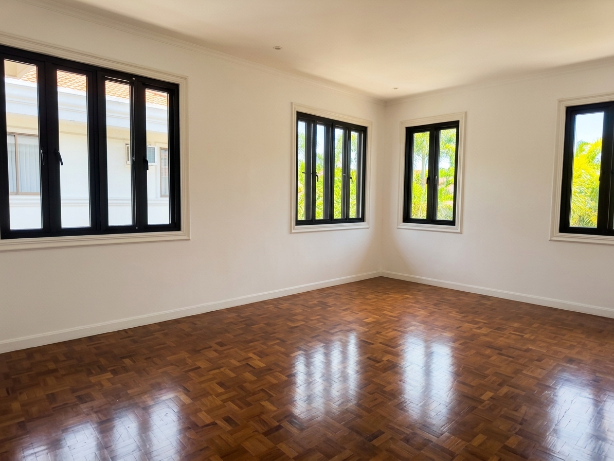 Bright bedroom with parquet floors and garden-facing windows