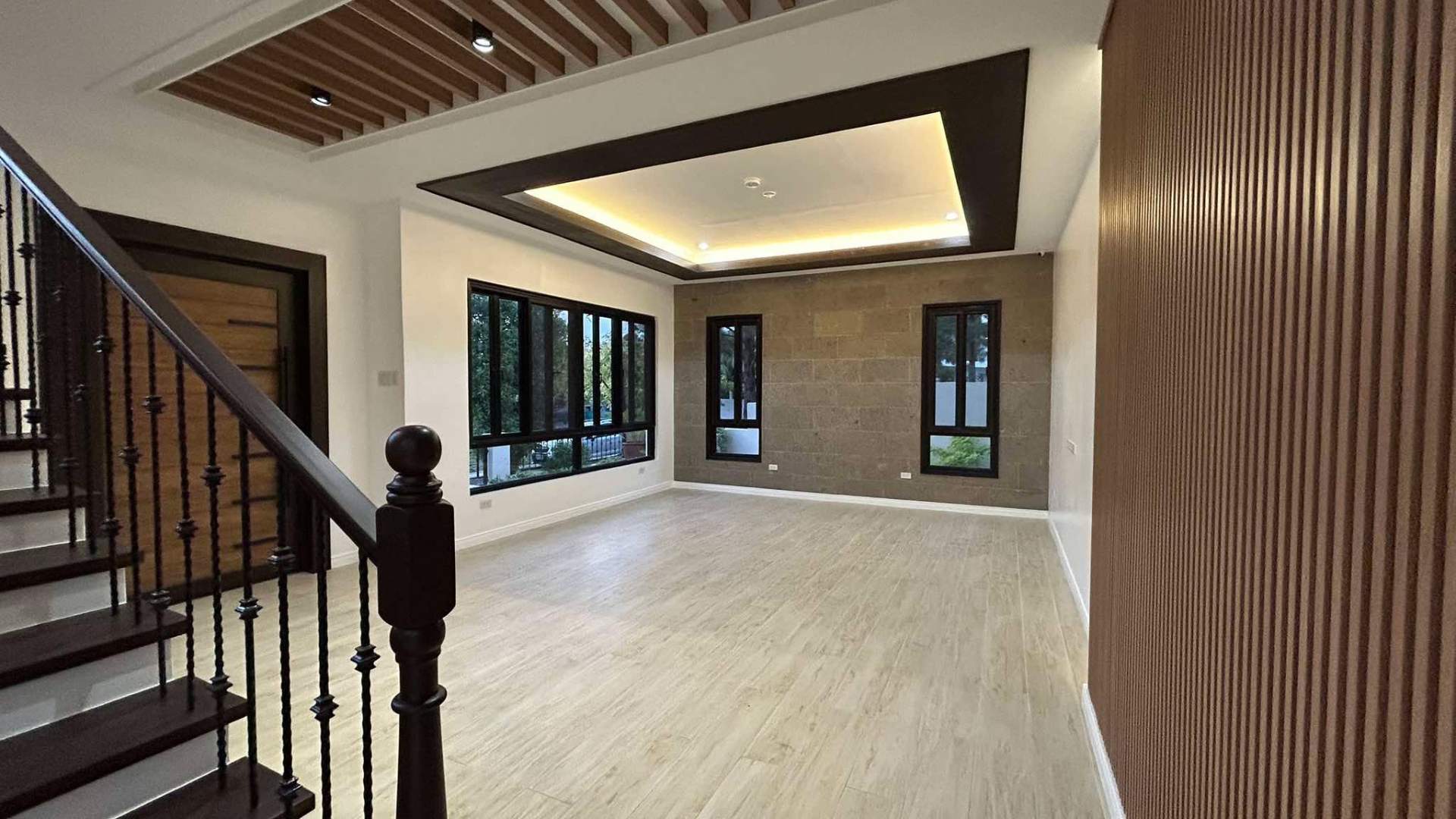 Foyer with slatted wood detailing and adobe stone feature wall