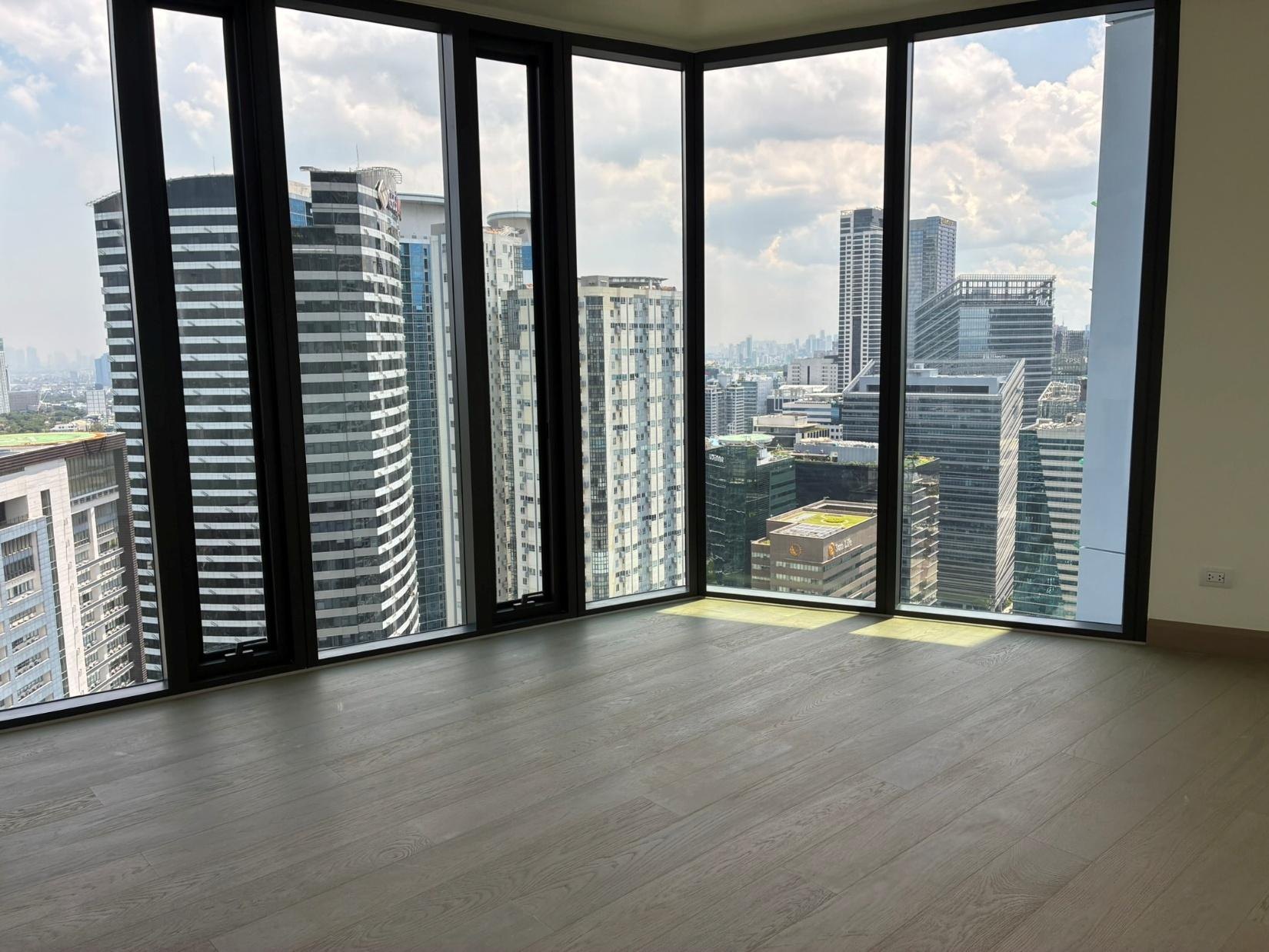 Master bedroom with floor-to-ceiling windows over the city skyline